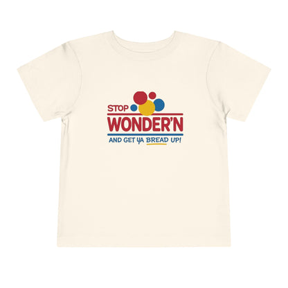 Beige t-shirt with colorful text design 'stop wondering ' on a white background